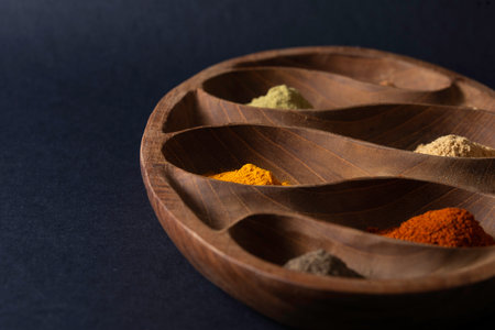 Colourful various herbs and spices for cooking on dark backgroundの写真素材