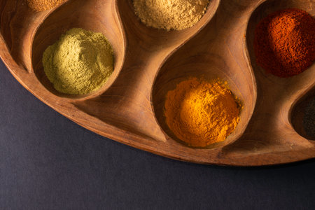 Colourful various herbs and spices for cooking on dark backgroundの写真素材