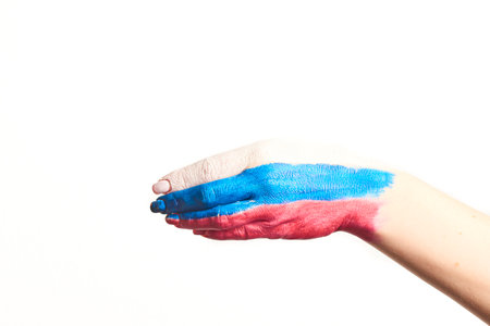 Russia flag painted on hand - isolated on white backgroundの写真素材