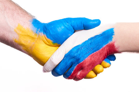 Flags of Ukraine and Russia Flag on hands isolated on white background. Concept of political, economical, social aggressions, disagreement.の写真素材