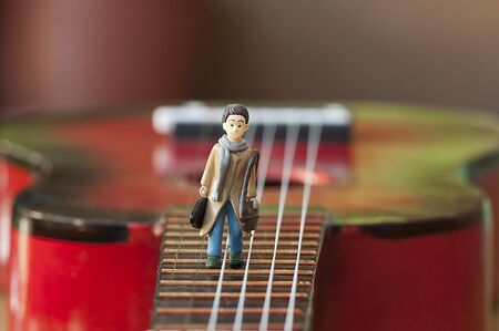 Miniature figurine, artist walking on a guitar 1の写真素材