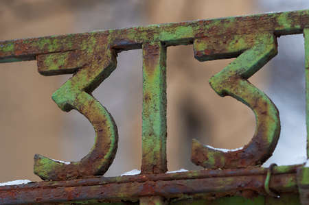 Number 33 on gate. Decoration on a fence. Exterior