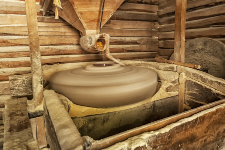 Making corn flour. Wooden water mill interior. Long exposure.の写真素材