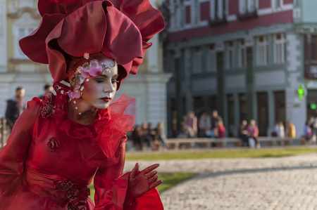 TIMISOARA, ROMANIA - March 31, 2017: Woman in red dress at the CheckArt Carnaval. Living statue. Union Square.のeditorial素材