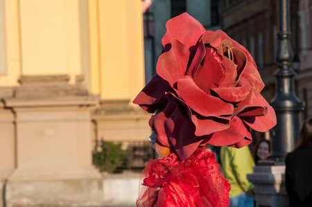 TIMISOARA, ROMANIA - March 31, 2017: Woman in red dress at the CheckArt Carnaval. Living statue. Union Square.のeditorial素材