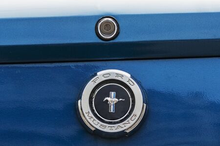 TIMISOARA ROMANIA - APRIL 22 2017: Old Ford Mustang displayed on a retro car parade. Back logo close-up.のeditorial素材