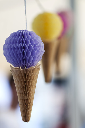 Icecream decorations hanging on a string. Shallow depth of field.の写真素材