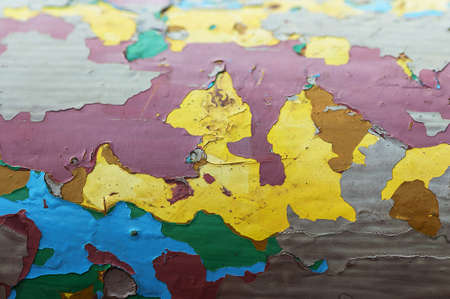 Peeling paint on a metal bar. Multiple layers of colored paint.の写真素材