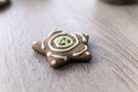 Christmas homemade gingerbread cookies on a wooden table. Star shape;