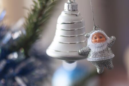 Christmas tree globe ornament. Santa and bell on fir tree branches.の写真素材