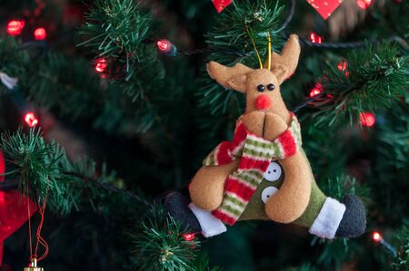 Reindeer decoration. Christmas tree globe ornament. Baubles on fir tree branches.