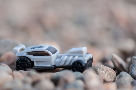 Toy car on gravel. Shallow depth of field.の写真素材