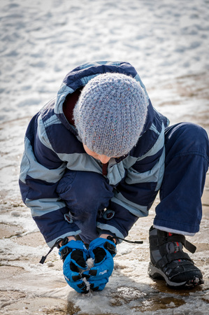 Child playing with snow. Kid making a snowball. Unrecognizable.の写真素材