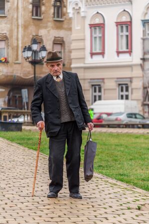 TIMISOARA, ROMANIA - JANUARY 20, 2014: Old man using a walking stickのeditorial素材