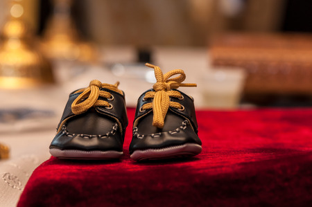 Close-up of small shoes on a table. Newborn fashion, clothingの写真素材