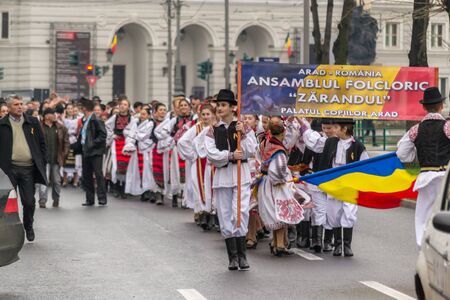 ARAD, ROMANIA - DECEMBER 1, 2012: People wearing national costumes at the National Day parade in Aradのeditorial素材