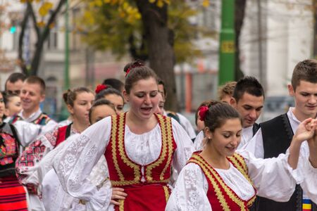 ARAD, ROMANIA - DECEMBER 1, 2012: People wearing national costumes at the National Day parade in Aradのeditorial素材