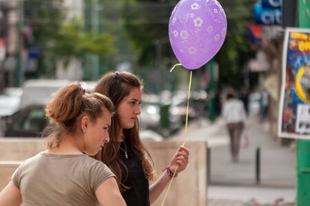 TIMISOARA, ROMANIA - JUNE 01, 2016: Girl holding a balloon. Real people.のeditorial素材