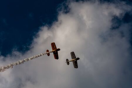 Aerobatics planes flying in the sky with clouds in the backgroundの写真素材
