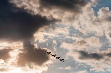 Aerobatics planes flying in the sky with clouds in the background