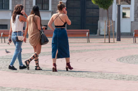 Three women walking on the street. Real people. View from behind.のeditorial素材