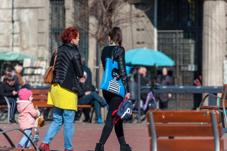 People walking on the street, in the city. Real people. View from behind.のeditorial素材