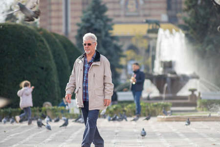 TIMISOARA, ROMANIA - NOVEMBER 17, 2019: Man walking on the street. Real people.のeditorial素材