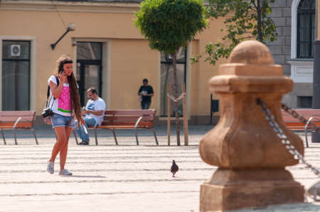 TIMISOARA, ROMANIA - SEPTEMBER 15, 2016: Woman walking on the street. Real people.のeditorial素材