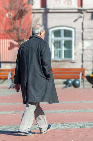 Old man walking in the street. Real people. View from behindのeditorial素材