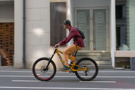TIMISOARA, ROMANIA - APRIL 04, 2019: Man riding his bicycle on the street. Real people.のeditorial素材