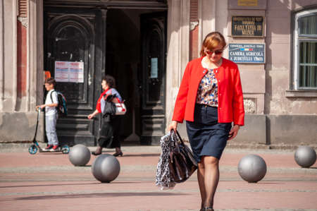 Timisoara, Romania - April 13, 2016: Woman walking on the street. Real people.のeditorial素材