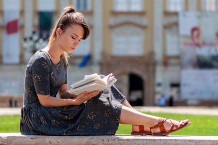 Timisoara, Romania - August 09, 2017: Young woman reading a bookのeditorial素材