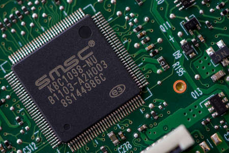 TIMISOARA, ROMANIA - NOVEMBER 10, 2019: Close-up of a SMSC KBC1098-NU integrated circuit. Electronic...