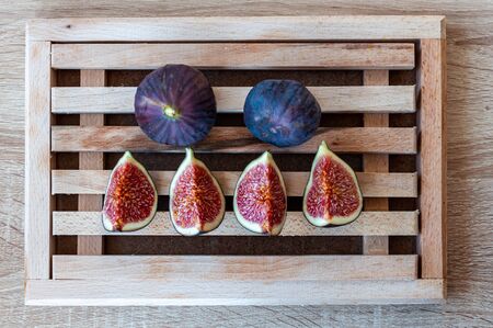 Fresh fig fruit on a wooden cutting board.
