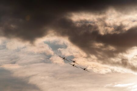 Aerobatics planes flying in the sky with clouds in the backgroundの写真素材