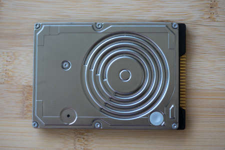 Top view of a hard disk drive on a wooden table