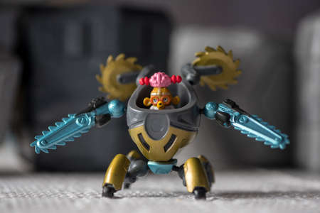 Close-up on toy robots with small people inside