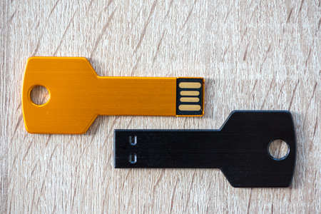 Close-up of a pen drive, flash disk sitting on a disk drive. Key chain shape.