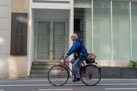 TIMISOARA, ROMANIA - APRIL 04, 2019: Man riding his bicycle on the street. Real people.