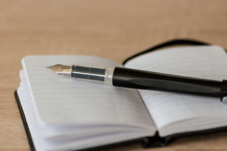Close-up of a fountain pen on a notebook. Copy space.の写真素材