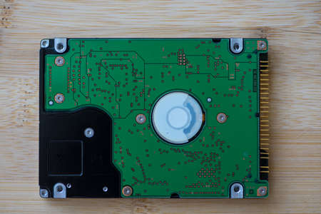 Top view of a hard disk drive on a wooden table