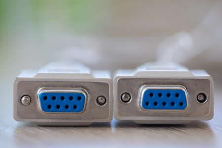 Close-up of a RS-232 serial port. Female to female extension cord on a wooden table.の写真素材