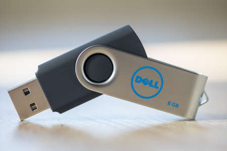 TIMISOARA, ROMANIA - JUNE 30, 2019: Close-up of a DELL pen drive, flash disk sitting on a disk driveのeditorial素材