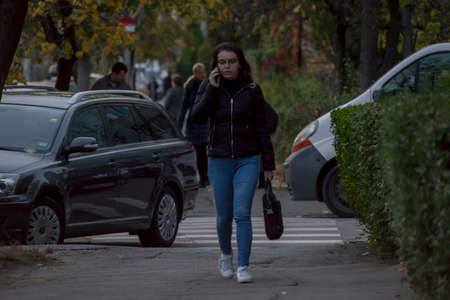TIMISOARA, ROMANIA - NOVEMBER 17, 2019: Woman walking on the street. Real people.のeditorial素材