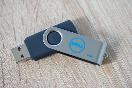 TIMISOARA, ROMANIA - JUNE 30, 2019: Close-up of a DELL pen drive, flash disk sitting on a disk driveのeditorial素材