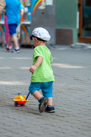 Child playing with a toy in the streetの写真素材