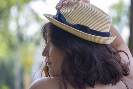 Portrait of a woman wearing a straw hat