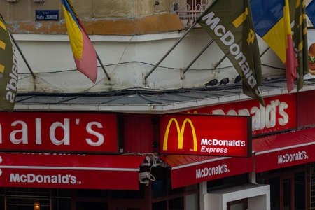 Timisoara, Romania - October 13, 2012: Close-up of the McDonalds building with flags and pigeons on...