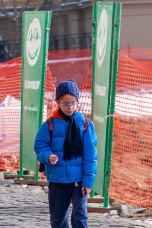Timisoara, Romania - January 30, 2014: Kid walking on the street. Real people.のeditorial素材
