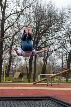 Timisoara, Romania - February 16, 2013: Kids jumping on a trampoline in a park. Real people.